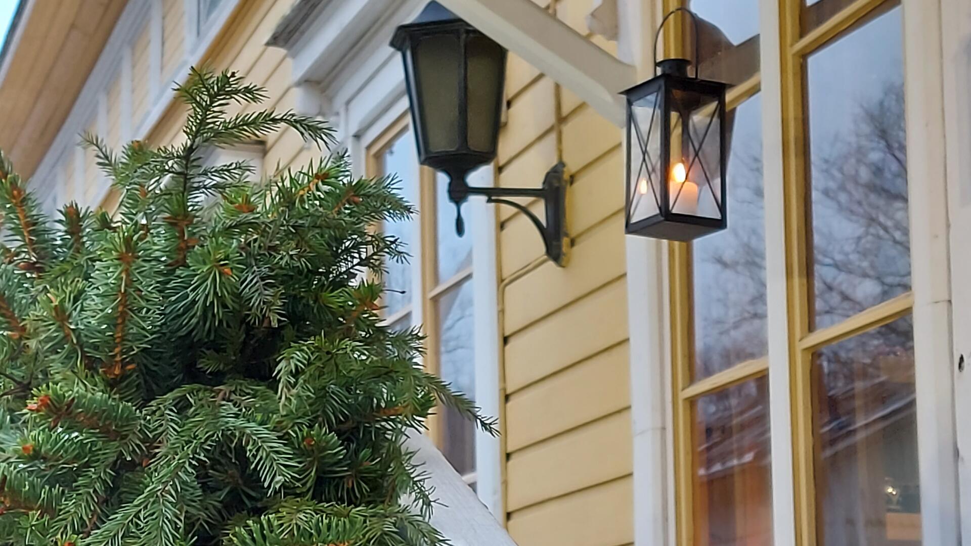Havuköynnös Naantalin museon portailla ja taustalla kynttilälyhty ikkunan edessä.